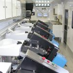 inside of the trailer showing multiple automated fish marking stations