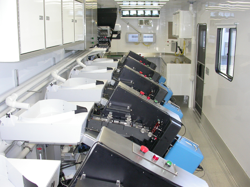 inside of the trailer showing multiple automated fish marking stations