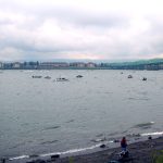 Boats in river next to bridge